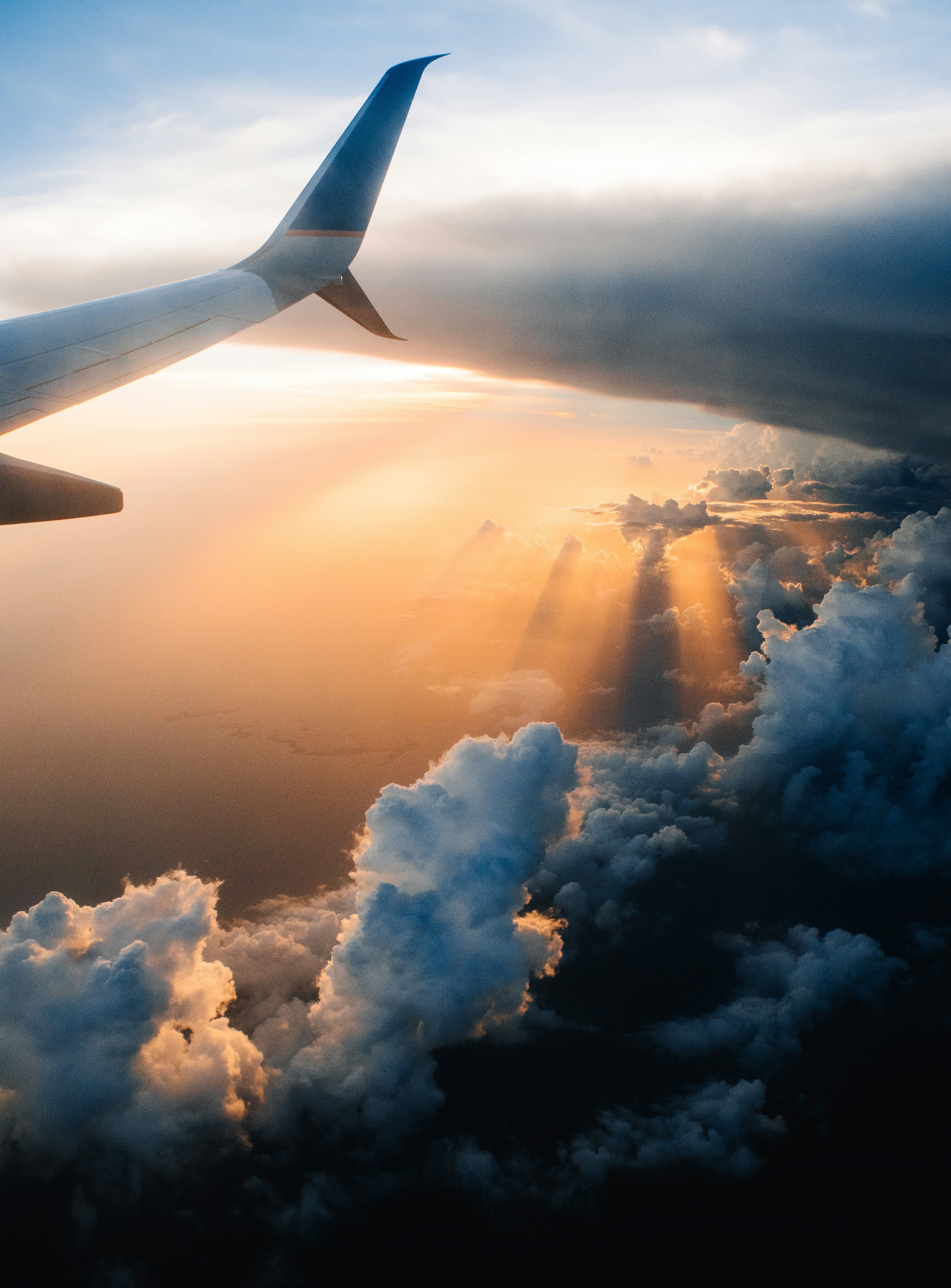 Image of a plane in the air at sunset